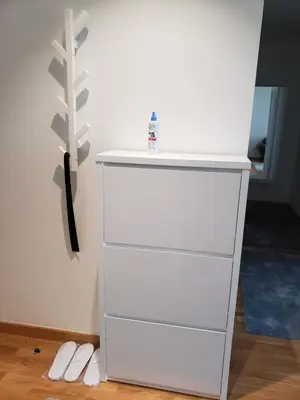 a white dresser in a room with white shoes at B-G Waterfront Apartment in Belgrade