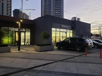 a car parked in a parking lot in front of a building at B-G Waterfront Apartment in Belgrade
