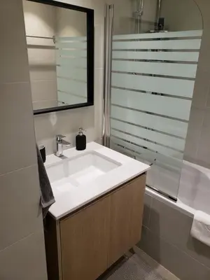 a bathroom with a sink and a bath tub at B-G Waterfront Apartment in Belgrade