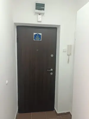 a brown door with a sign on it in a building at Sleep&Go in Belgrade