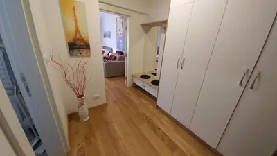 a room with a hallway with a vase on the floor at Apartments Delta A Blok - Savada in Belgrade