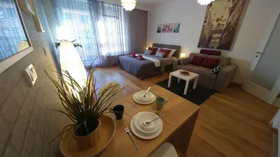 a living room with a couch and a table at Apartments Delta A Blok - Savada in Belgrade