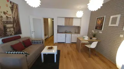 a living room with a couch and a table at Apartments Delta A Blok - Savada in Belgrade