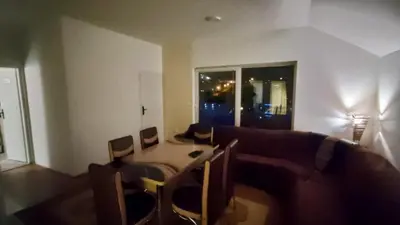 a living room with a couch and a table at Apartmani Mladenović in Kijevo