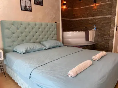 a bedroom with a large bed with two towels on it at President app Arandjelovac in Arandjelovac