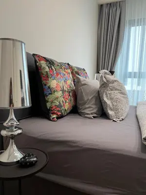 a bed with pillows and a table with a mirror at Belgrade Waterfront Escape 104 in Belgrade