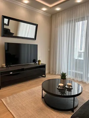 a living room with a large television and a coffee table at Belgrade Waterfront Escape 104 in Belgrade