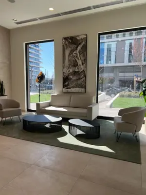 a living room with two chairs and a couch and tables at Belgrade Waterfront Escape 104 in Belgrade
