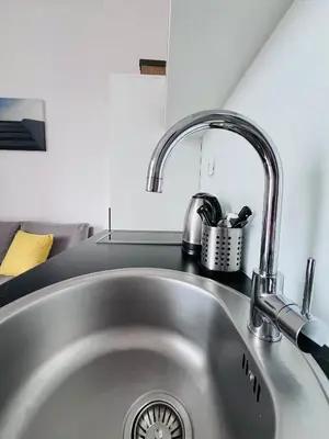 a kitchen sink with a faucet on top of it at You will love it, in Vracar in Belgrade