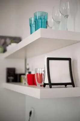 a shelf with wine glasses and a mirror on it at You will love it, in Vracar in Belgrade