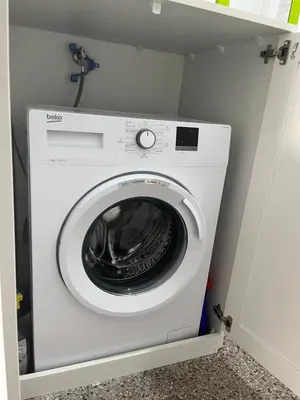 a white washing machine in a small room at You will love it, in Vracar in Belgrade
