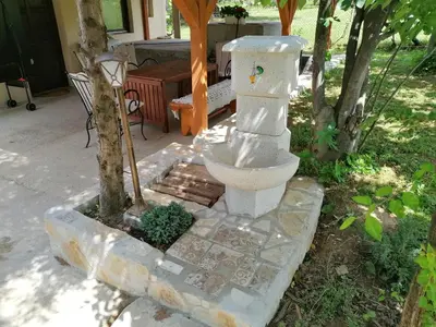 a statue of a toilet sitting in a yard at Vila Mila Fruška Gora in Velika Remeta