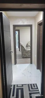 a living room with a chair and a mirror at Centar_park in Arandjelovac