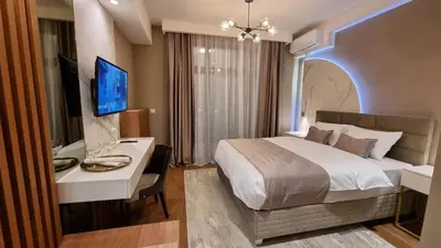 a bedroom with a bed and a desk and a television at Belgrade Waterfront-Beograd na vodi - BW Arcadia Lux in Belgrade