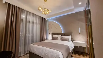 a bedroom with a large bed and a chandelier at Belgrade Waterfront-Beograd na vodi - BW Arcadia Lux in Belgrade