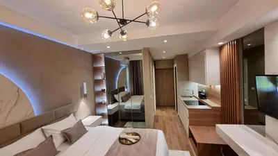 a living room with a white couch and a television at Belgrade Waterfront-Beograd na vodi - BW Arcadia Lux in Belgrade