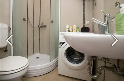 a bathroom with a sink and a washing machine at Višegradska in Sajmište