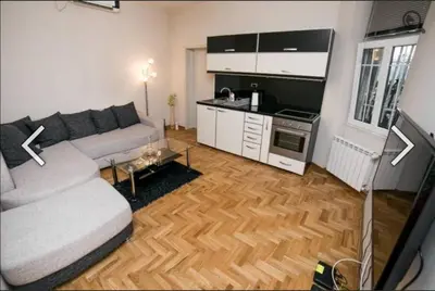 a living room with a couch and a kitchen at Višegradska in Sajmište