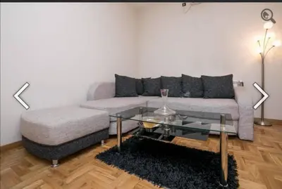 a living room with a couch and a glass table at Višegradska in Sajmište