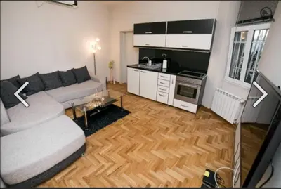 a living room with a couch and a kitchen at Višegradska in Sajmište