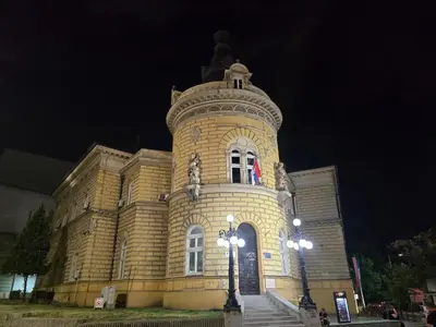 a building with a clock tower at night at Angelina 03. in Belgrade
