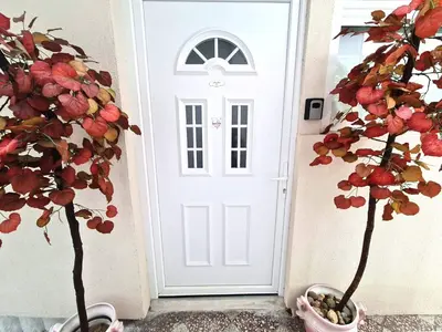 a white door with two potted trees in front of it at Angelina 03. in Belgrade