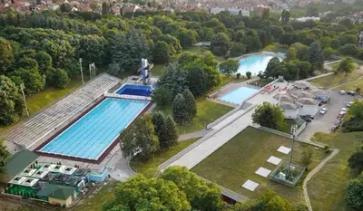 an overhead view of a swimming pool in a park at Cozy green house (free parking spot) in Belgrade