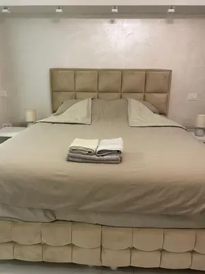 a large bed with two towels on top of it at Liga apartment in Vračar (historical)