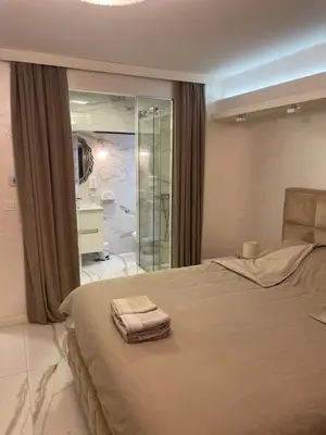 a bedroom with a large bed with a glass window at Liga apartment in Vračar (historical)