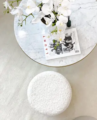 a round white table with a white rug and white flowers at Lolita Lux - Belgrade Waterfront in Belgrade