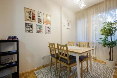 a dining room with a table and chairs at Sava Centar 1-bedroom apartments in the heart of New Belgrade in Belgrade
