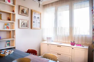a dining room with a table and a window at Sava Centar 1-bedroom apartments in the heart of New Belgrade in Belgrade