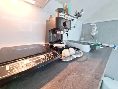 a kitchen with a coffee maker on top of a stove at Angelina 2 in Belgrade
