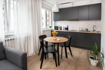 a kitchen with a table and chairs in a room at Apartment Vracar Belgrade, St Sava Church Park in Belgrade
