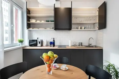 a kitchen with a wooden table with a bowl of fruit at Apartment Vracar Belgrade, St Sava Church Park in Belgrade