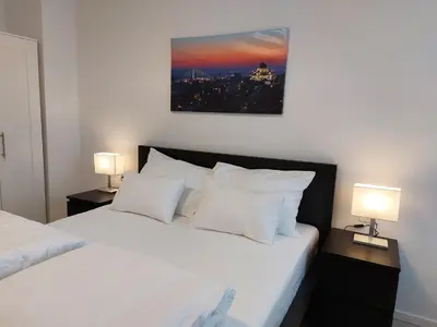 a bedroom with two beds and two lamps at Apartment Vracar Belgrade, St Sava Church Park in Belgrade