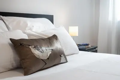 a bird pillow sitting on top of a bed at Apartment Vracar Belgrade, St Sava Church Park in Belgrade