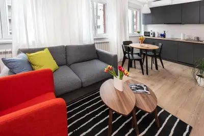 a living room with a couch and a table at Apartment Vracar Belgrade, St Sava Church Park in Belgrade