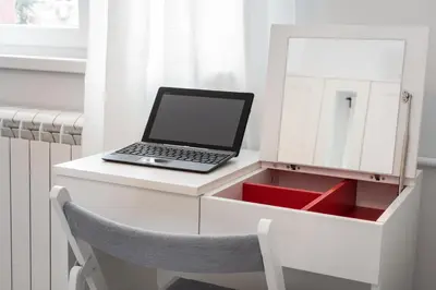 a laptop computer sitting on a white desk with a mirror at Apartment Vracar Belgrade, St Sava Church Park in Belgrade