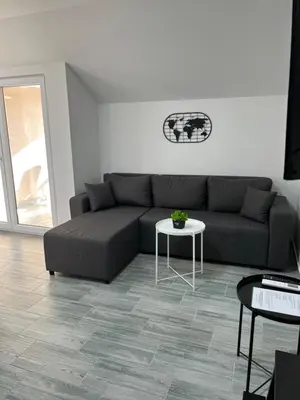 a living room with a couch and a table at Aster Apartments in Belgrade
