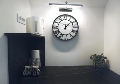 a clock on a wall in a room at Aster Apartments in Belgrade