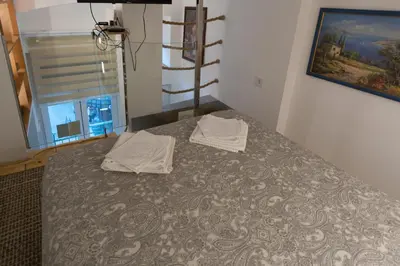 a bed with two towels sitting on top of it at City Passage Apartments in Belgrade