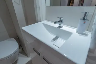 a bathroom with a white sink and a toilet at City Passage Apartments in Belgrade
