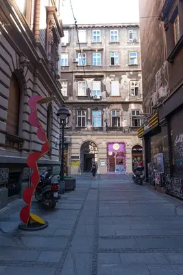 an empty street in a city with a building at City Passage Apartments in Belgrade