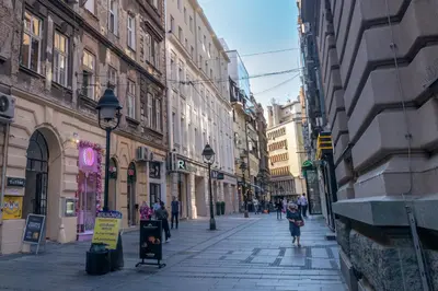a city street with people walking down the street at City Passage Apartments in Belgrade