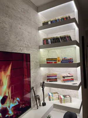 a living room with a tv and a fireplace at Garden House Lux in Belgrade