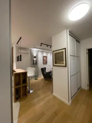 a living room with a desk and a chair at Garden House Lux in Belgrade