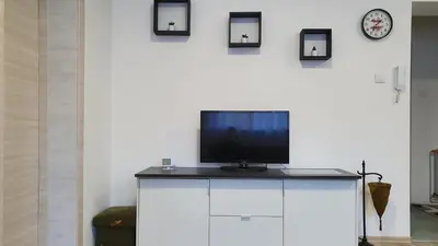 a television sitting on top of a white cabinet at IMPERIUM stan na dan in Inđija