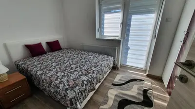 a bedroom with a bed and a window at IMPERIUM stan na dan in Inđija