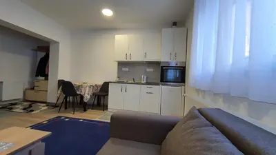 a living room with a couch and a kitchen at IMPERIUM stan na dan in Inđija
